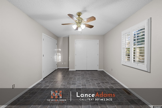 396 Williams Way, Glenrock, WY 82637 - foyer with stone finish flooring, ceiling fan, a textured ceiling, and baseboards