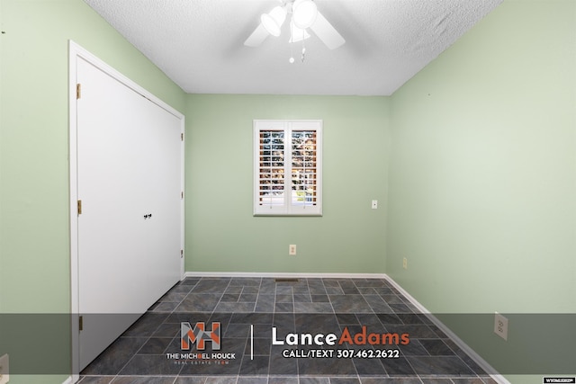 396 Williams Way, Glenrock, WY 82637 - unfurnished bedroom featuring a textured ceiling, baseboards, and ceiling fan