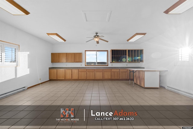 396 Williams Way, Glenrock, WY 82637 - kitchen with plenty of natural light, light tile patterned floors, a baseboard radiator, and baseboards