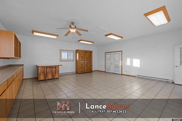 396 Williams Way, Glenrock, WY 82637 - kitchen featuring a baseboard radiator, ceiling fan, light countertops, and light tile patterned flooring