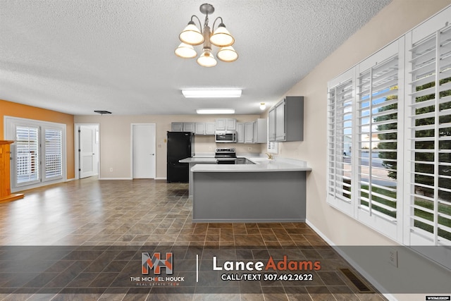 396 Williams Way, Glenrock, WY 82637 - kitchen with stainless steel appliances, a textured ceiling, a sink, a peninsula, and gray cabinets