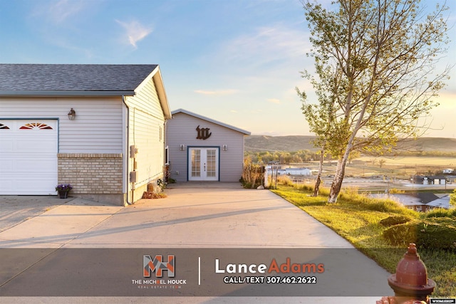 396 Williams Way, Glenrock, WY 82637 - view of outbuilding featuring french doors, driveway, and a garage