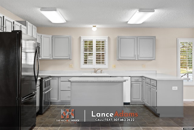 396 Williams Way, Glenrock, WY 82637 - kitchen featuring freestanding refrigerator, double oven range, a sink, a peninsula, and light countertops