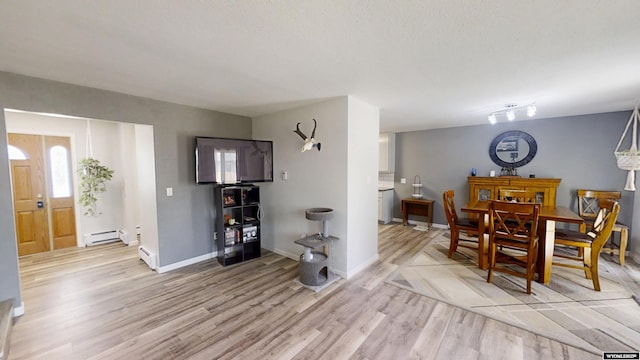 205 Daffodil, Casper, WY 82604 - dining space featuring light wood-type flooring, baseboard heating, and baseboards