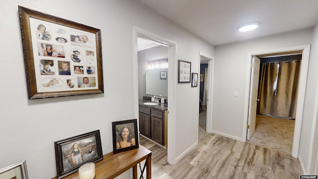 205 Daffodil, Casper, WY 82604 - hallway featuring light wood-type flooring, a sink, and baseboards