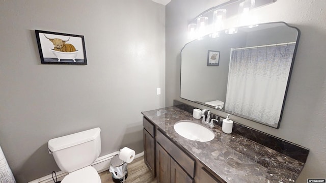 205 Daffodil, Casper, WY 82604 - bathroom with vanity, toilet, wood finished floors, a shower with curtain, and baseboards