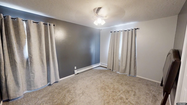 205 Daffodil, Casper, WY 82604 - carpeted empty room featuring baseboards, baseboard heating, and a textured ceiling