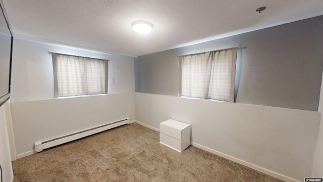 205 Daffodil, Casper, WY 82604 - carpeted spare room with baseboard heating, baseboards, and a textured ceiling