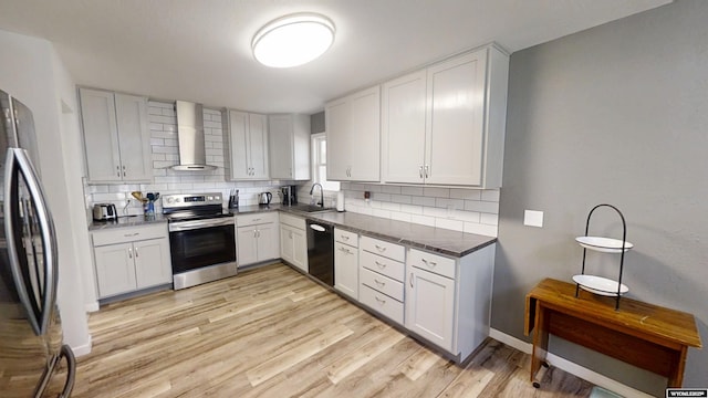 205 Daffodil, Casper, WY 82604 - kitchen with stainless steel appliances, wall chimney range hood, decorative backsplash, and a sink