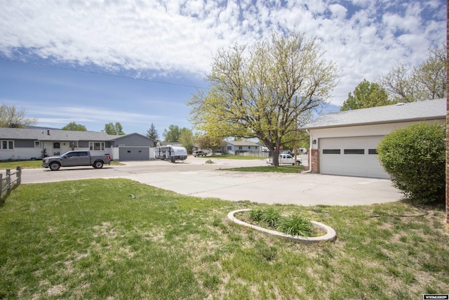 205 Daffodil, Casper, WY 82604 - view of green lawn featuring concrete driveway, a garage, and a residential view