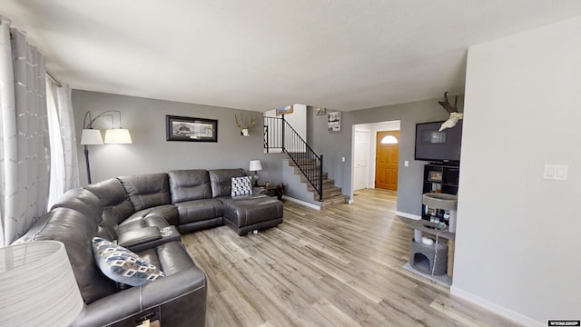 205 Daffodil, Casper, WY 82604 - living area with stairway, light wood-style flooring, and baseboards