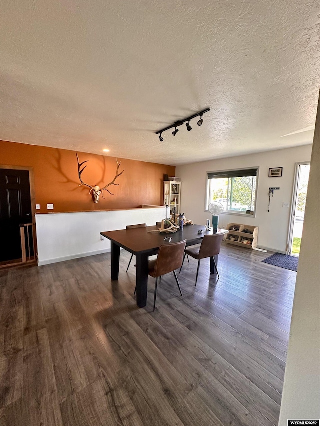 1595 S Riverbend Dr, Green River, WY 82935 - dining space with dark wood finished floors, a textured ceiling, track lighting, and baseboards