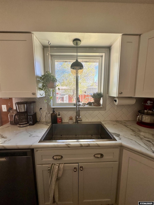 1595 S Riverbend Dr, Green River, WY 82935 - kitchen featuring dishwasher, a sink, white cabinetry, and tasteful backsplash