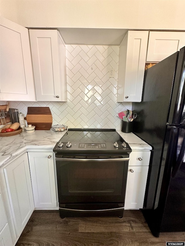 1595 S Riverbend Dr, Green River, WY 82935 - kitchen with electric range oven, freestanding refrigerator, decorative backsplash, and white cabinets