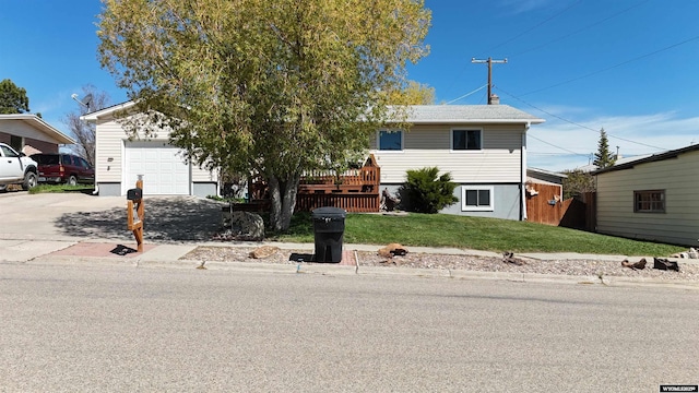 715 Emerald St, Kemmerer, WY 83101 - view of front of house with a front lawn, a garage, and driveway