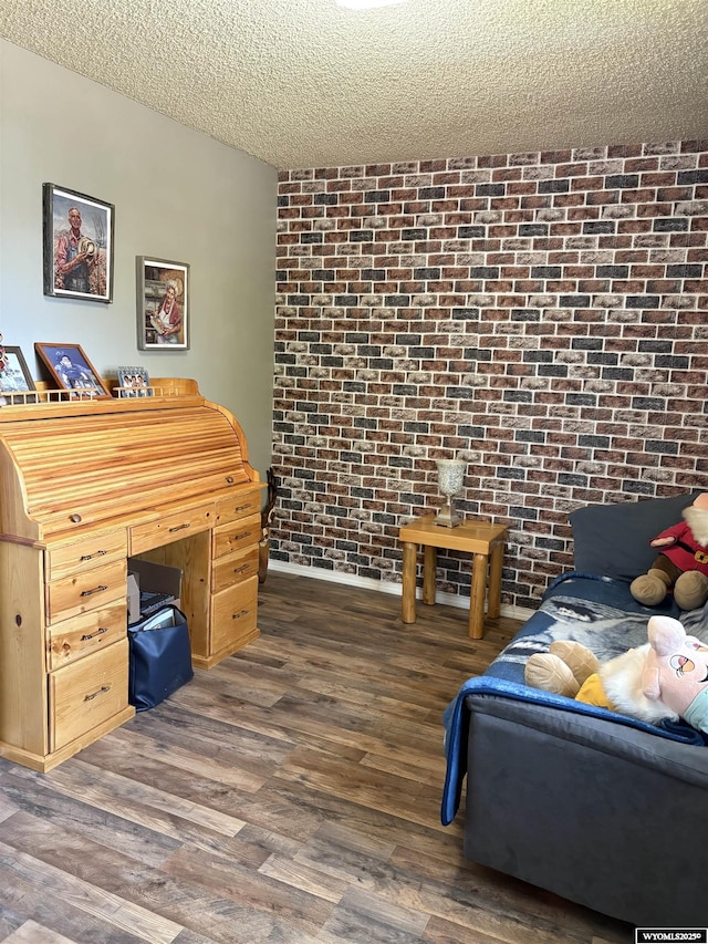 715 Emerald St, Kemmerer, WY 83101 - bedroom with brick wall, wood finished floors, and a textured ceiling
