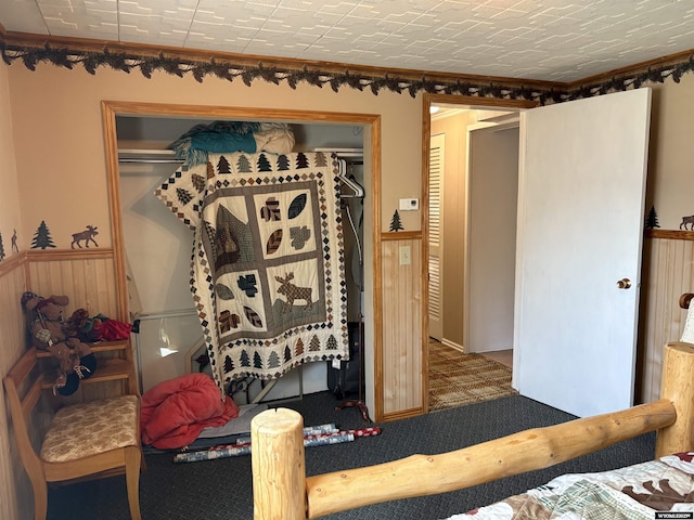 715 Emerald St, Kemmerer, WY 83101 - bedroom featuring a closet, carpet, and ornamental molding