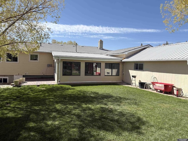 715 Emerald St, Kemmerer, WY 83101 - back of house featuring a yard, a chimney, and a deck