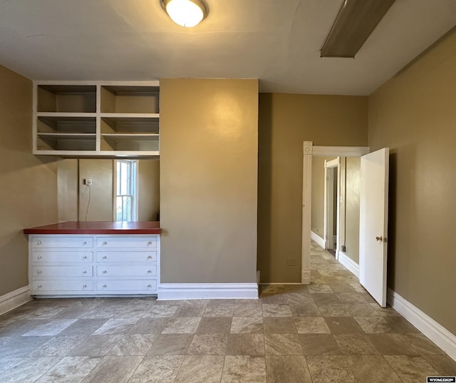 596 Garfield St, Lander, WY 82520 - empty room with stone finish floors and baseboards