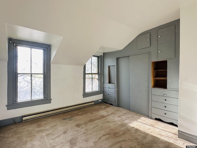 596 Garfield St, Lander, WY 82520 - bonus room featuring a baseboard radiator, lofted ceiling, carpet floors, and healthy amount of natural light