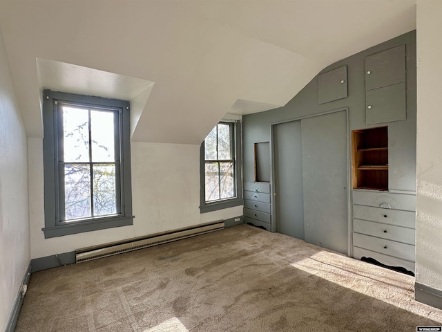 596 Garfield St, Lander, WY 82520 - unfurnished bedroom with baseboard heating, lofted ceiling, carpet flooring, and multiple windows