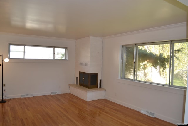104 First St, Mountain View, WY 82939 - unfurnished living room featuring wood finished floors, baseboards, and crown molding