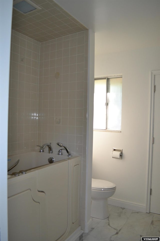 104 First St, Mountain View, WY 82939 - bathroom featuring a tub to relax in, marble finish flooring, baseboards, and toilet