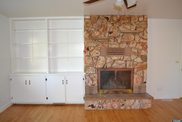 104 First St, Mountain View, WY 82939 - unfurnished living room featuring light wood finished floors, a ceiling fan, a fireplace, and baseboards