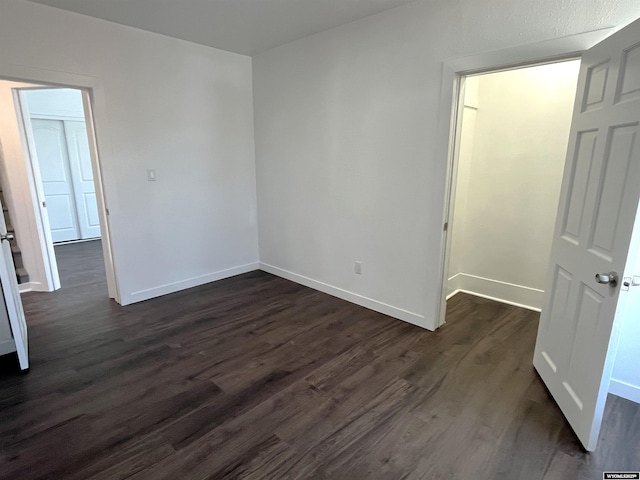 1137 Main St, Evanston, WY 82930 - empty room with dark wood finished floors and baseboards