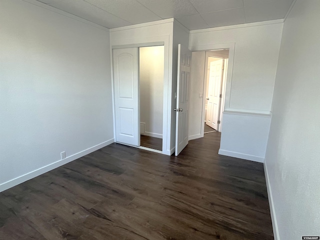 1137 Main St, Evanston, WY 82930 - unfurnished bedroom featuring dark wood finished floors, crown molding, a closet, and baseboards