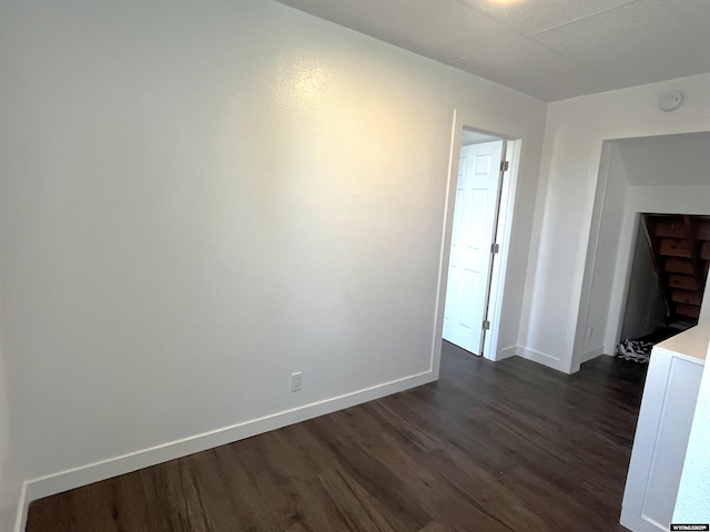 1137 Main St, Evanston, WY 82930 - empty room with dark wood-style floors, baseboards, and a smoke detector