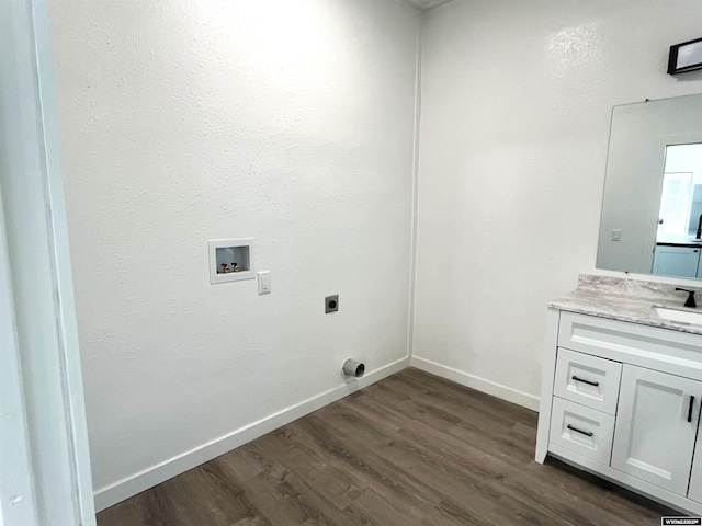 1137 Main St, Evanston, WY 82930 - washroom with electric dryer hookup, dark wood-type flooring, washer hookup, baseboards, and cabinet space