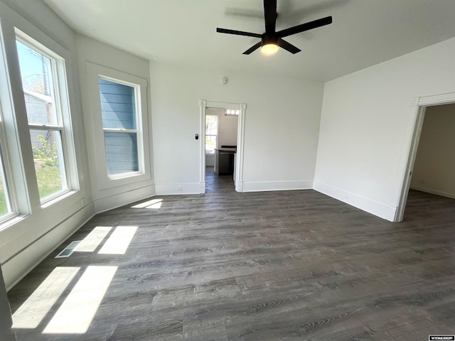1137 Main St, Evanston, WY 82930 - spare room with plenty of natural light, dark wood-style floors, baseboards, and a ceiling fan