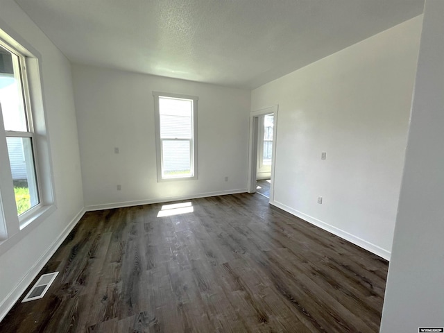 1137 Main St, Evanston, WY 82930 - unfurnished room featuring plenty of natural light, dark wood-type flooring, and baseboards