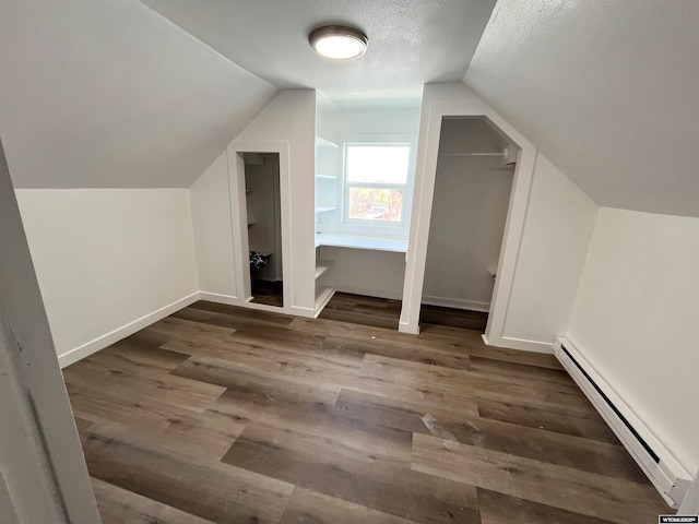 1137 Main St, Evanston, WY 82930 - bonus room with a baseboard radiator, lofted ceiling, wood finished floors, baseboards, and a textured ceiling