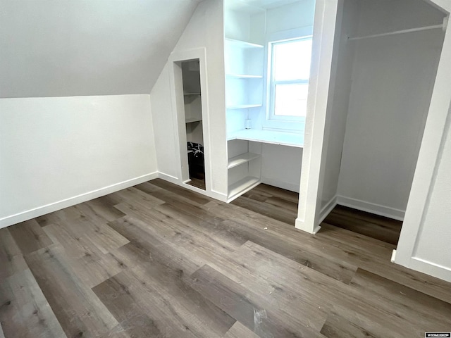 1137 Main St, Evanston, WY 82930 - bonus room featuring built in shelves, wood finished floors, baseboards, and lofted ceiling
