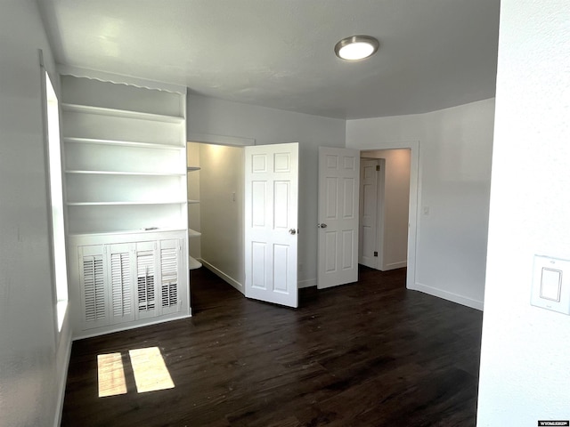 1137 Main St, Evanston, WY 82930 - unfurnished bedroom with dark wood-style floors and baseboards