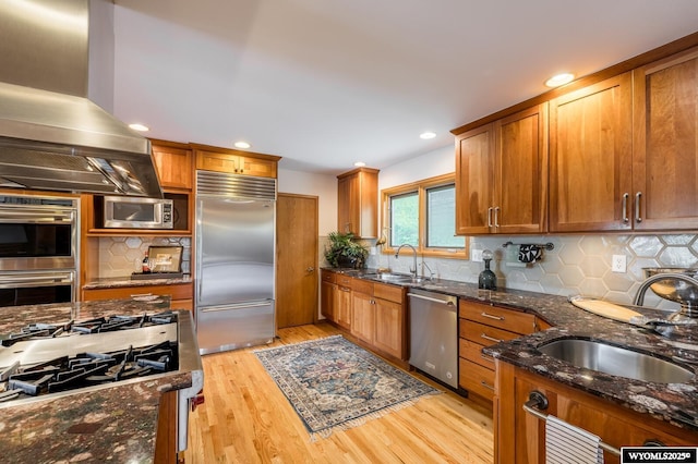 370 Aster, Casper, WY 82604 - kitchen with stainless steel appliances, island exhaust hood, a sink, brown cabinets, and recessed lighting