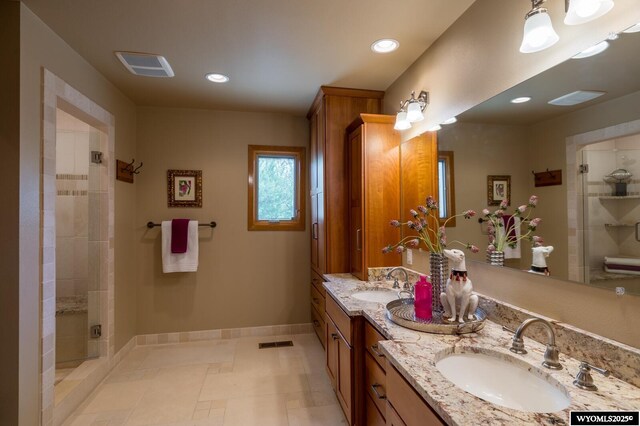 370 Aster, Casper, WY 82604 - bathroom with double vanity, baseboards, a shower stall, and recessed lighting