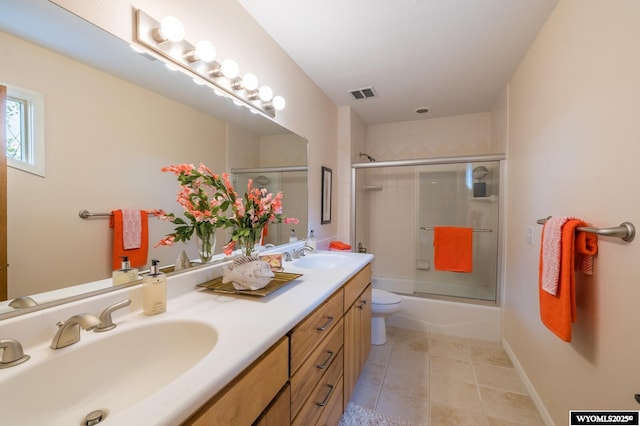 370 Aster, Casper, WY 82604 - full bath featuring double vanity, tile patterned floors, bath / shower combo with glass door, and toilet