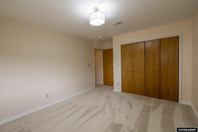 370 Aster, Casper, WY 82604 - unfurnished bedroom with light colored carpet, baseboards, and a closet