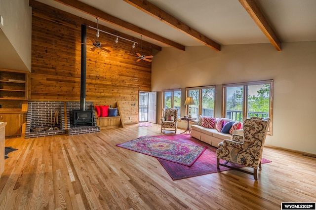 370 Aster, Casper, WY 82604 - living room with healthy amount of natural light, wood finished floors, wooden walls, a towering ceiling, and beam ceiling