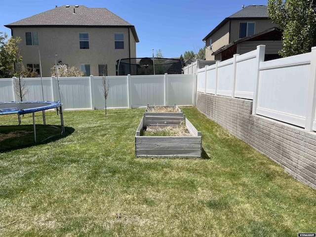 344 Via Assisi Dr, Rock Springs, WY 82901 - view of yard featuring a vegetable garden and a trampoline