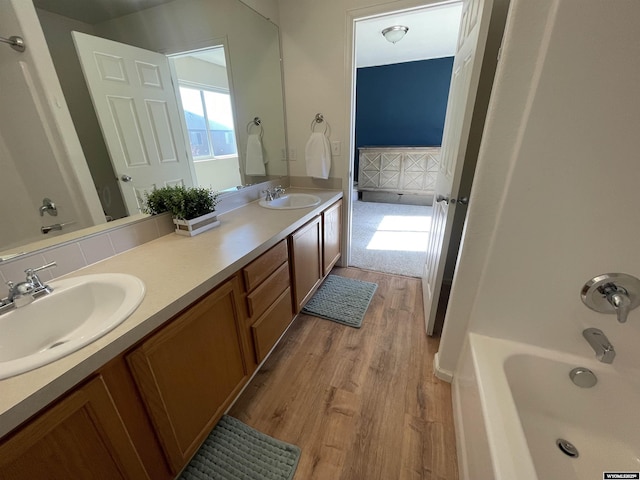 344 Via Assisi Dr, Rock Springs, WY 82901 - bathroom featuring wood finished floors and double vanity