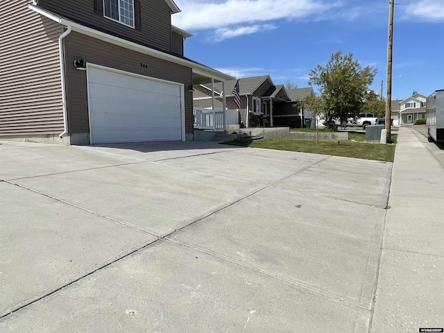 344 Via Assisi Dr, Rock Springs, WY 82901 - view of property exterior with an attached garage, concrete driveway, and a residential view