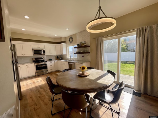 344 Via Assisi Dr, Rock Springs, WY 82901 - dining room with light wood-style floors and recessed lighting