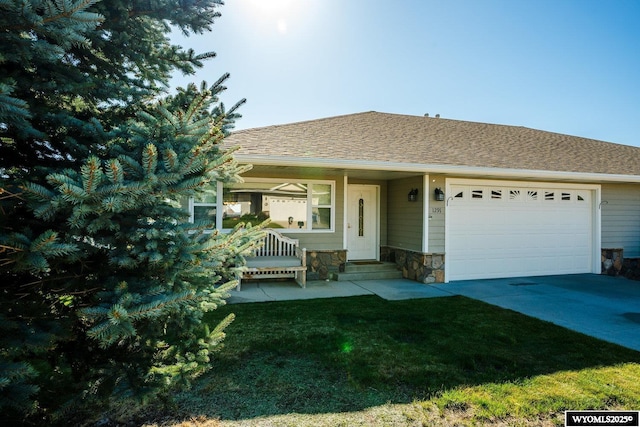 1291 Eagle View Dr, Buffalo, WY 82834 - view of front of house with a garage, a front lawn, driveway, stone siding, and roof with shingles