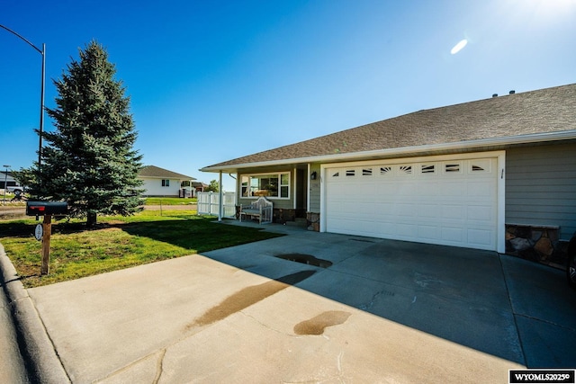 1291 Eagle View Dr, Buffalo, WY 82834 - single story home featuring driveway, a front lawn, an attached garage, stone siding, and roof with shingles