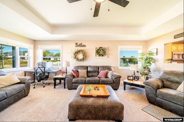 1291 Eagle View Dr, Buffalo, WY 82834 - carpeted living area featuring a raised ceiling, ceiling fan, healthy amount of natural light, and a desk