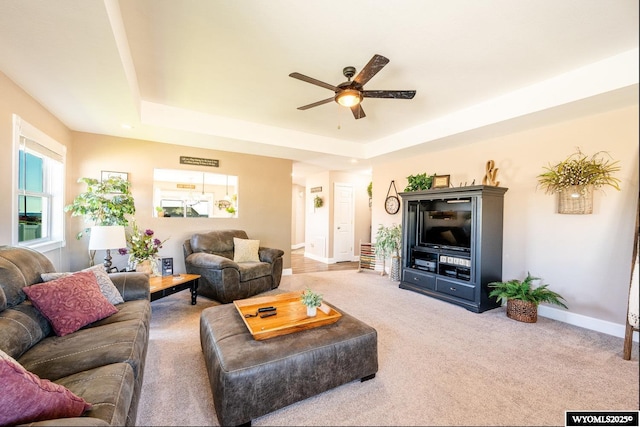 1291 Eagle View Dr, Buffalo, WY 82834 - living area with ceiling fan, a tray ceiling, carpet flooring, and baseboards